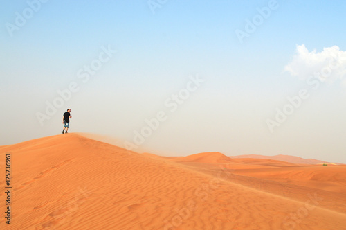 man in the setting sun in the desert