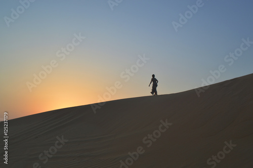 girl in the setting sun in the desert