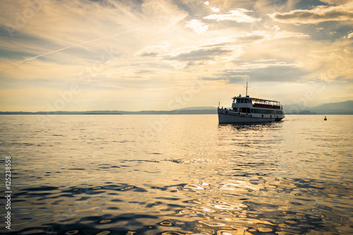 Ferry on Lake Garda at sunset.