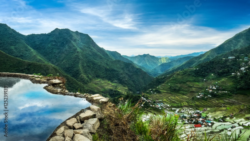 Amazing panorama view of rice terraces fields in Ifugao province mountains under cloudy blue sky. Banaue, Philippines UNESCO heritage photo