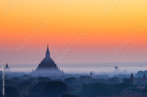 Tilt Shift blur effect. Amazing misty sunrise colors and silhouette of ancient Myauk Guni Pagoda. Architecture of ancient Buddhist Temples at Bagan Kingdom. Myanmar (Burma) travel destinations © PerfectLazybones