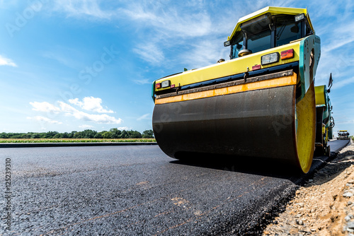 Road roller working on the construction site photo