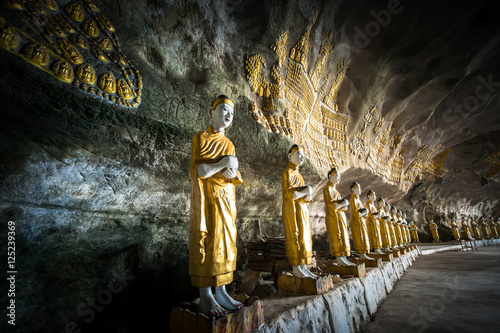 Amazing view of lot Buddhas statues and religious carving on limestone rock in sacred Sadan Sin Min cave. Hpa-An, Myanmar (Burma) travel landscapes and destinations photo
