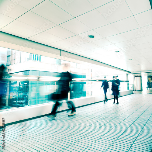 Abstract city background. Blurred image of people moving in tunnel at crowded street. Hong Kong. Blur effect, vintage style toning