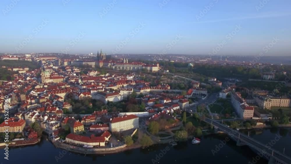 Flying over Prague in Czech Republic. Red rooftops of houses and view to Prague Castle, official Residence of President Flying over Prague in Czech Republic. Red rooftops of houses and view to Prague Castle, official Residence of President
