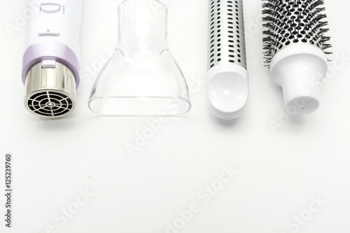 Obraz na plátně Collection electric hair dryer and hair curler in beauty salon, isolate on white background, Top view with copy space and text