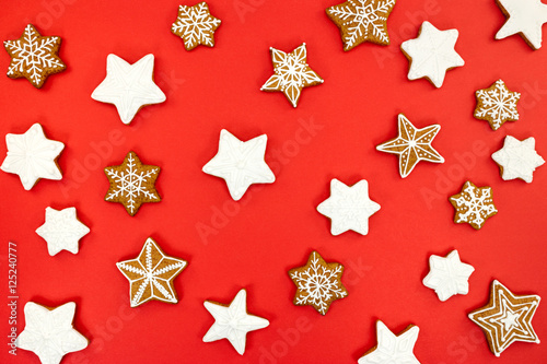 snowflake and star shaped christmas gingerbread cookies on red background