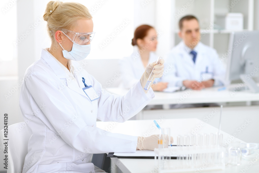 Scientific research team with clear solution in laboratory Scientific research team with clear solution in laboratory
