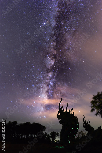 Amazing bright star milky way night sky and kink of Naga Wat Sirindhorn temple in Northeast Thailand .