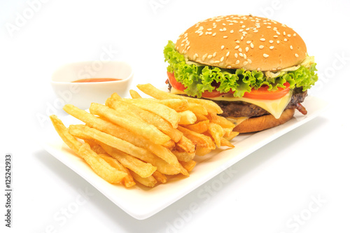 tasty hamburger, French fries and chili sauce on white plate, Fast food with copy space