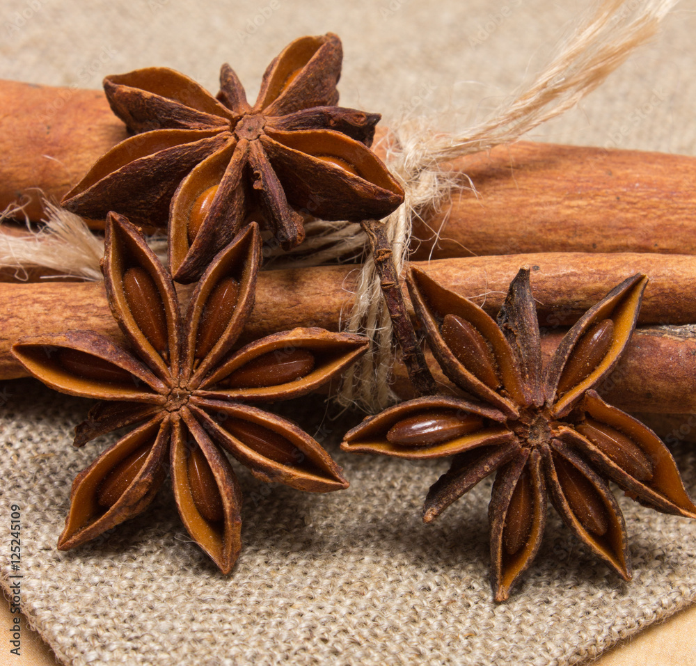Star anise and cinnamon sticks on wooden table, seasoning for cooking Star anise and cinnamon sticks on wooden table, seasoning for cooking