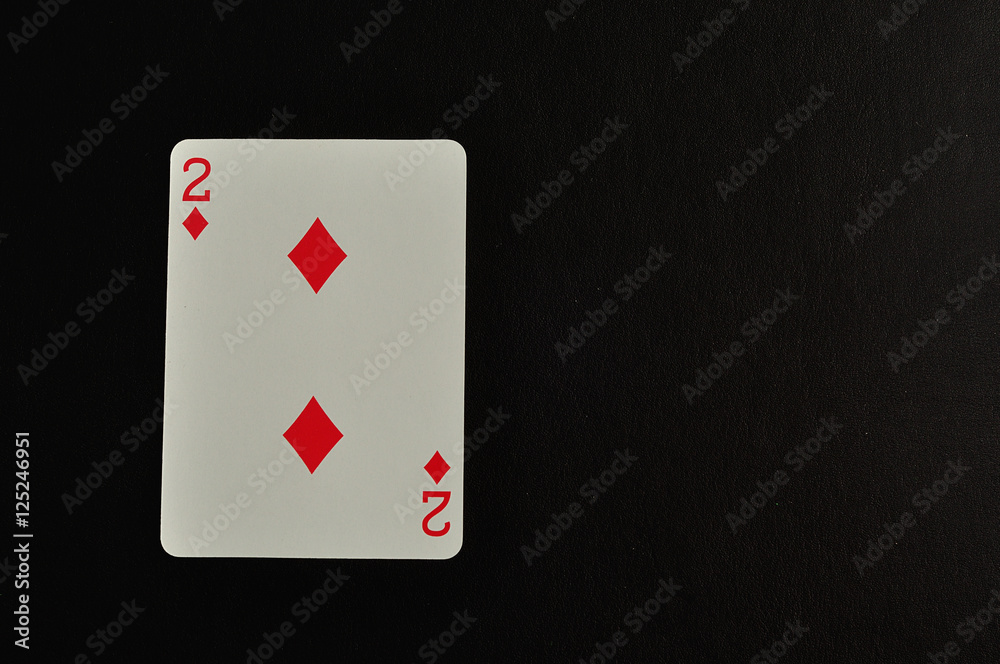 Playing card. Two of diamond isolated on a black background