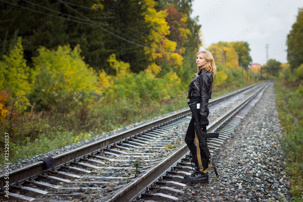 Girl with arms on the rails in autumn day Girl with arms on the rails in autumn day