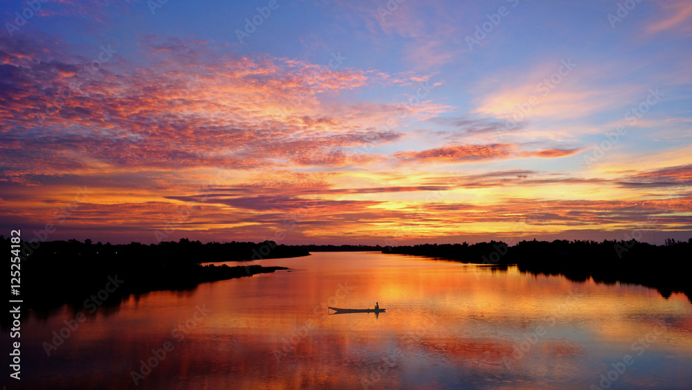 Red sky and cloud over the river with boat in Thailand, Ubonratchathani province