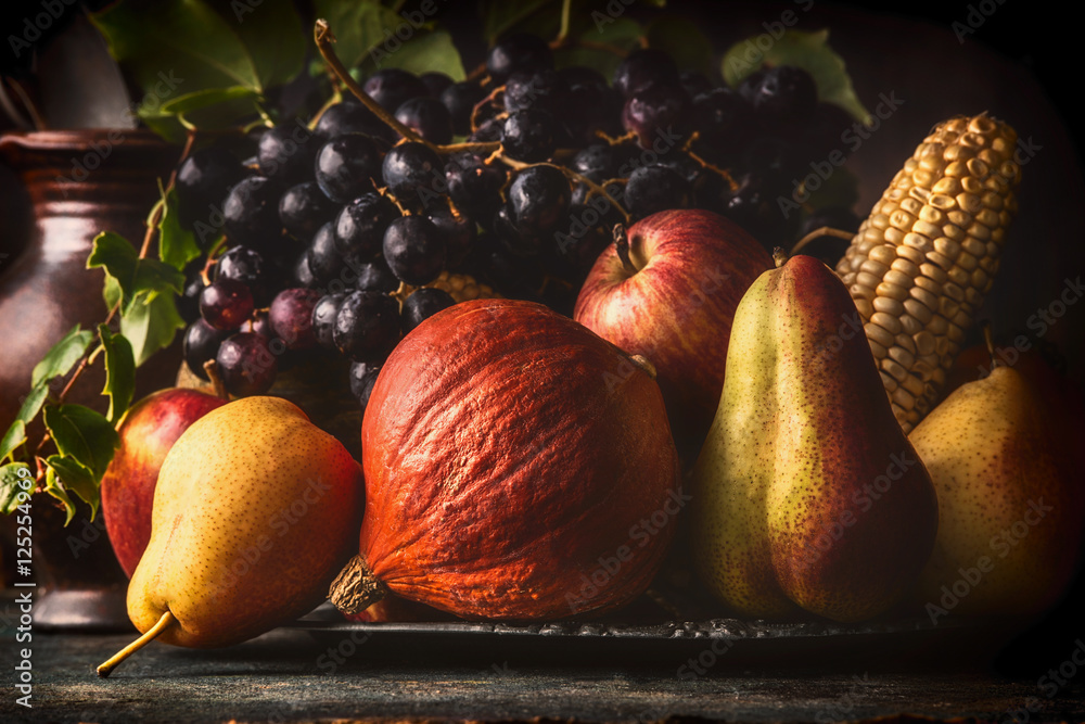 Still life with autumn fruits and vegetables: apples, pears, grapes ...