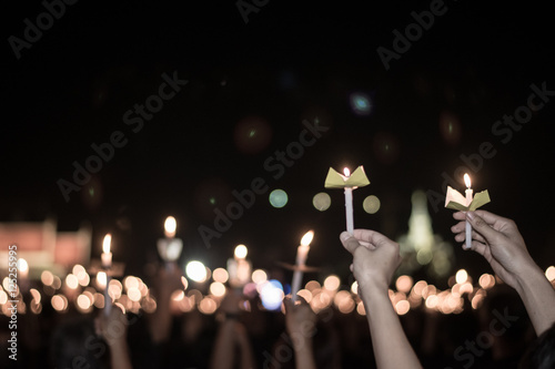 Blurred image for background of hand with candle memorable for King Bhumibol Adulyadej of thailand