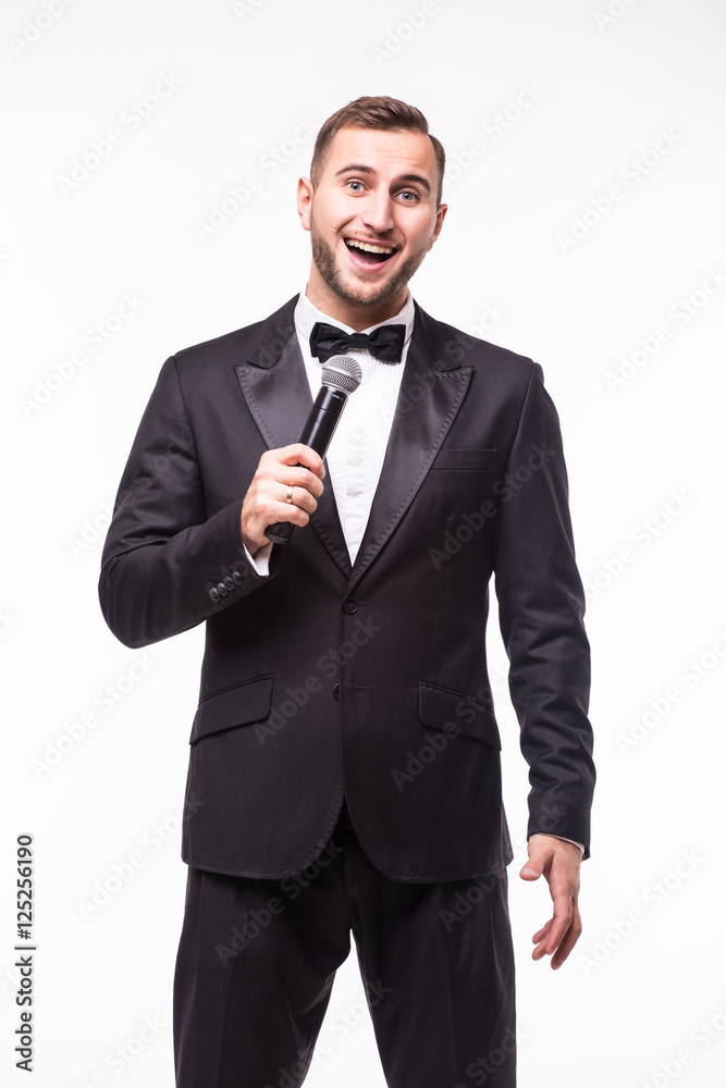 Young man in suit singing over the microphone with energy. Isolated on white background. Singer concept. Young man in suit singing over the microphone with energy. Isolated on white background. Singer concept.