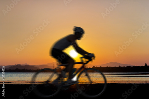 Cycling at beach on twilight © taitai6769