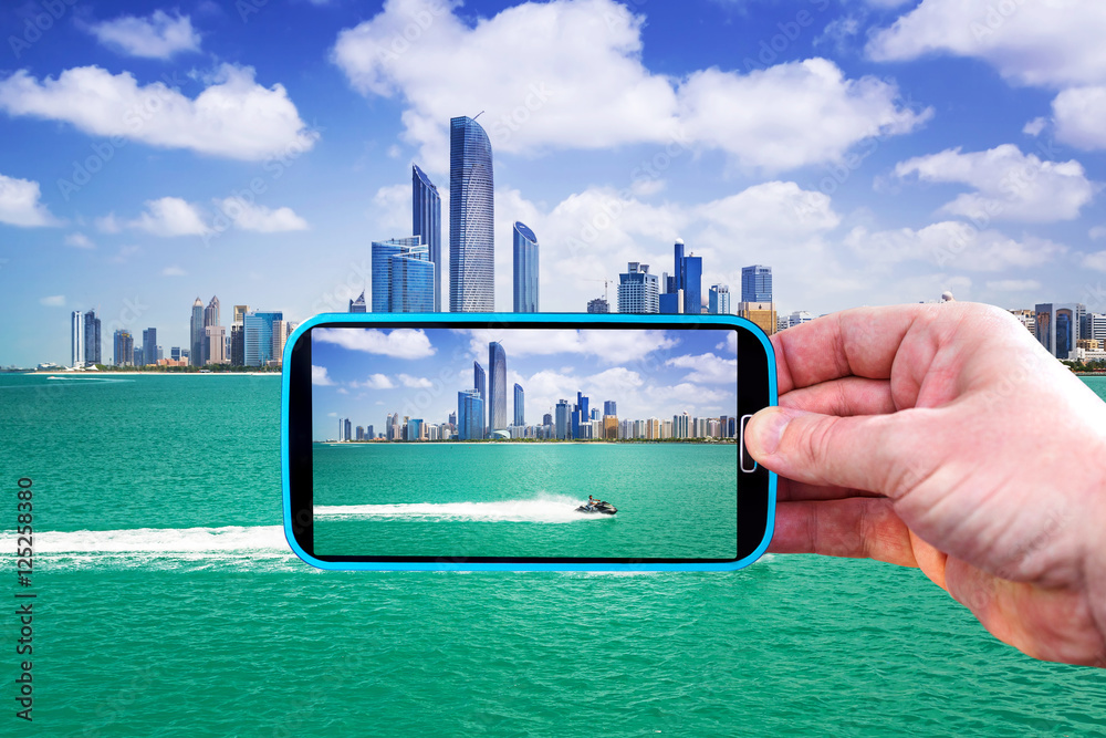 Fototapeta premium Making photos by smartphone in Abu Dhabi, UAE