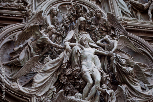 Принти на полотні Detail of the Pieta scene in bas-relief at Milan's Cathedral doors,