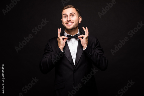 The showman in suit over black background. Showman concept.