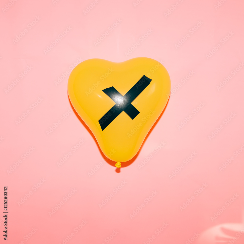 yellow balloon on pink background- direct flash used- freaky party concept yellow balloon on pink background- direct flash used- freaky party concept