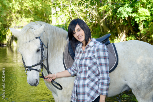 young rider girl with her white horse