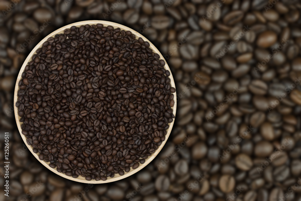 Coffee beans on the plate with coffee beans as a background Coffee beans on the plate with coffee beans as a background