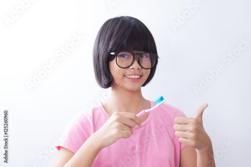 happy young girl with toothbrush