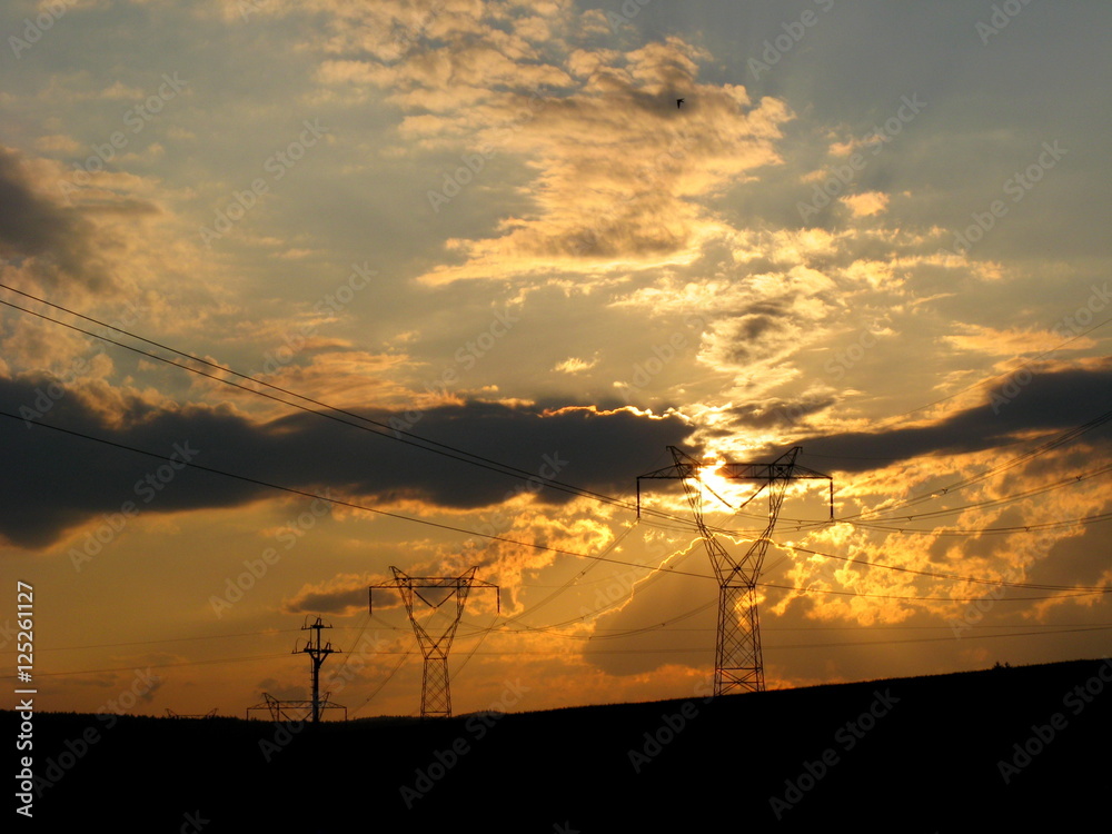 Sunset through high voltage power line