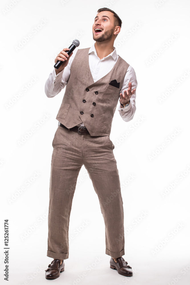 Young man in suit singing over the microphone with energy. Isolated on white background. Singer concept. Young man in suit singing over the microphone with energy. Isolated on white background. Singer concept.