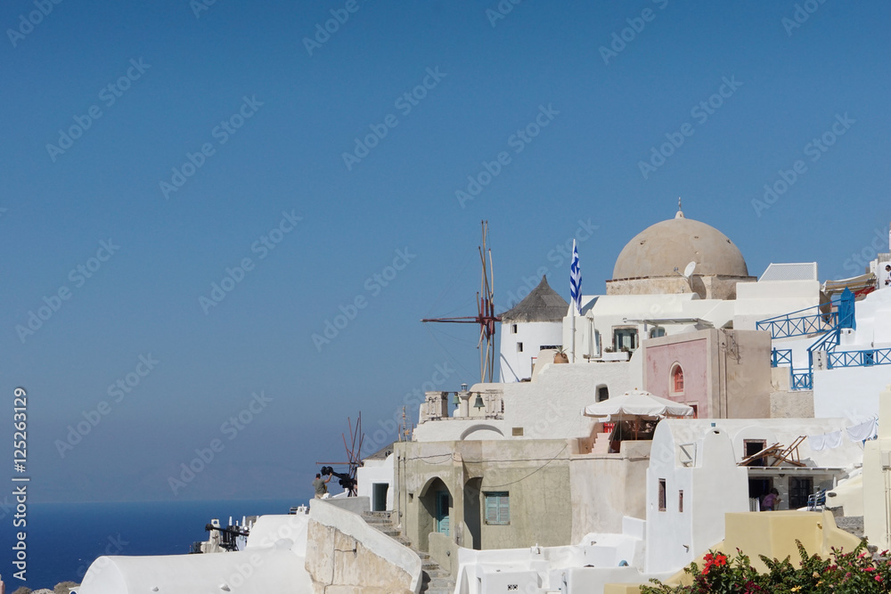 Windmill and white house village in Oia, Santorini.