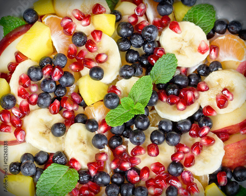  Fruit salad with various fresh organic fruits close-up 