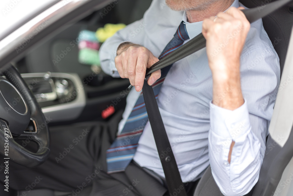 Driver fastening his seat belt