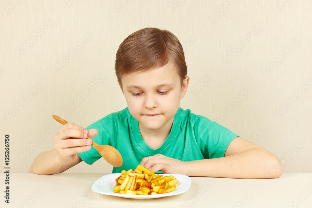 Little cut boy is going to eat a fries Little cut boy is going to eat a fries