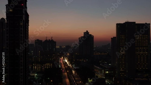 Wallpaper Mural Timelapse shot of dawn in Bangkok, Thailand. Sun rising in the sky over the capital. Cityscape with transport traffic across the channel Torontodigital.ca