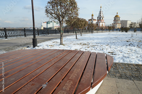 Irkutsk, Russia - Oct 27, 2016: Wooden benches of unusual shape - the gift of Sberbank to Irkutsk City photo