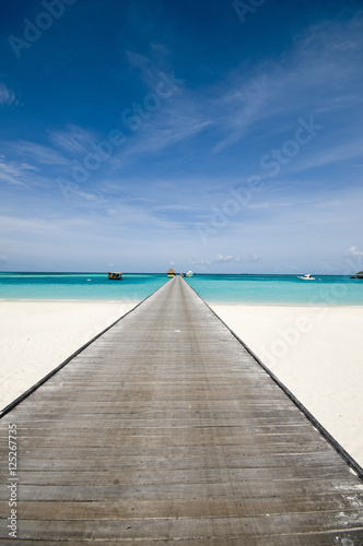 bridge into turquoise ocean of the maldives