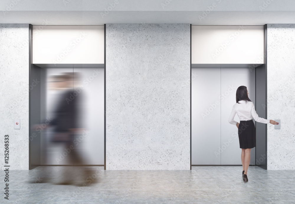 Fototapeta premium Two men and a woman in elevator hall
