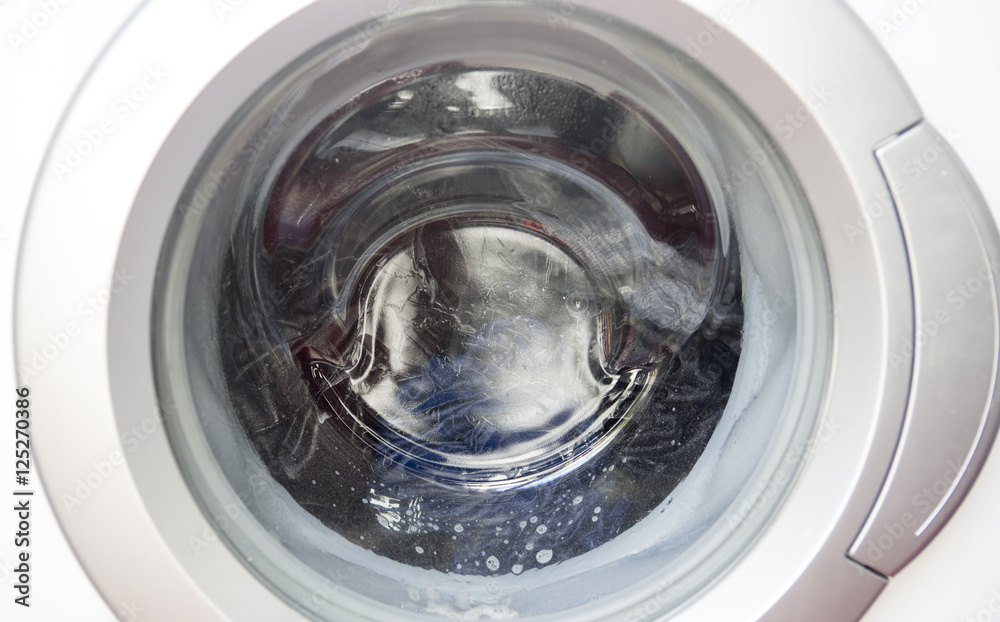 closeup of a running washing machine closeup of a running washing machine