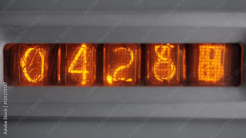The tube timer counts the seconds. Start counting. Numbers on the display of vintage vacuum tube timer. Close up. The tube timer counts the seconds. Start counting. Numbers on the display of vintage vacuum tube timer. Close up.