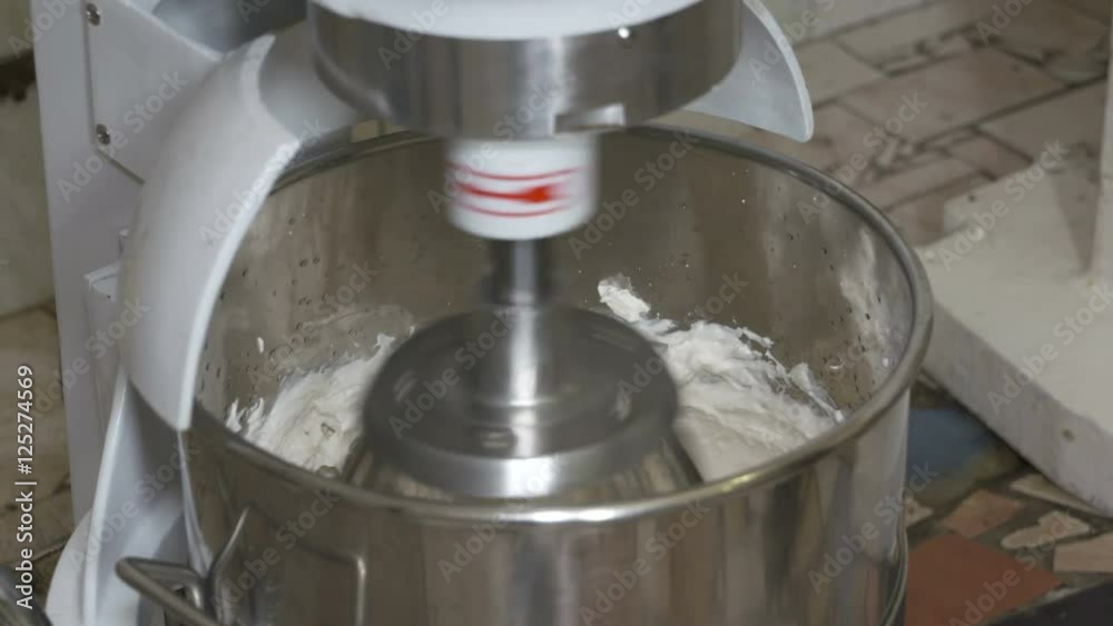 Process of whipping marshmallow mixture in planetary mixer at confectionery factory Process of whipping marshmallow mixture in planetary mixer at confectionery factory