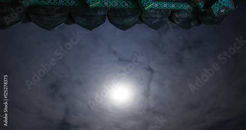 Night secene of Temple eaves with moon and clouds moving
