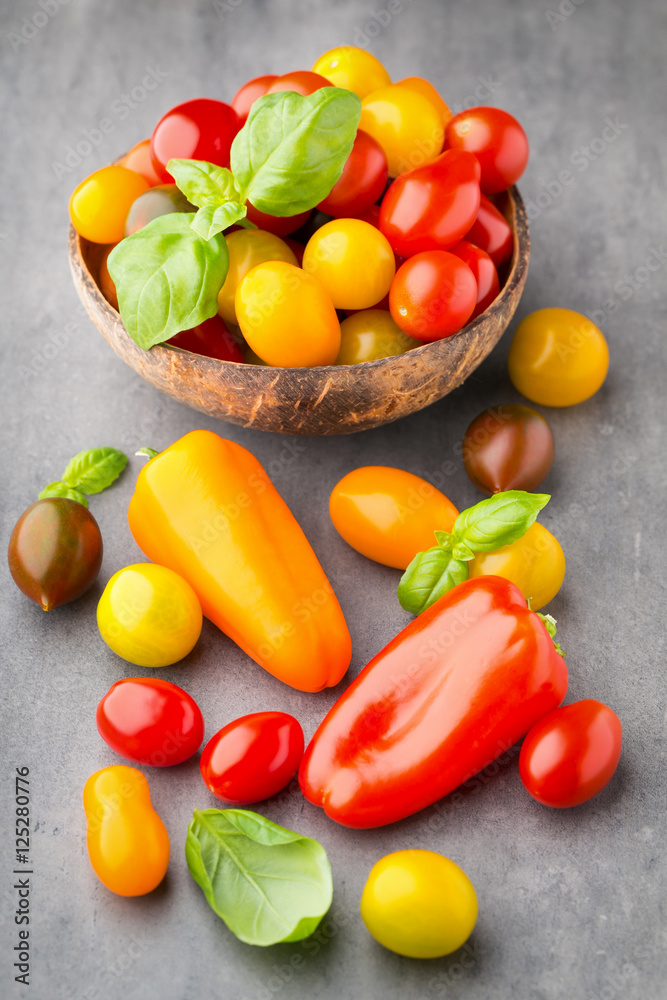 Tomatoes on the gray background. Colorful tomatoes, red tomatoes Tomatoes on the gray background. Colorful tomatoes, red tomatoes