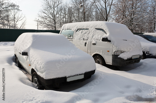 Cars covered with fresh white snow