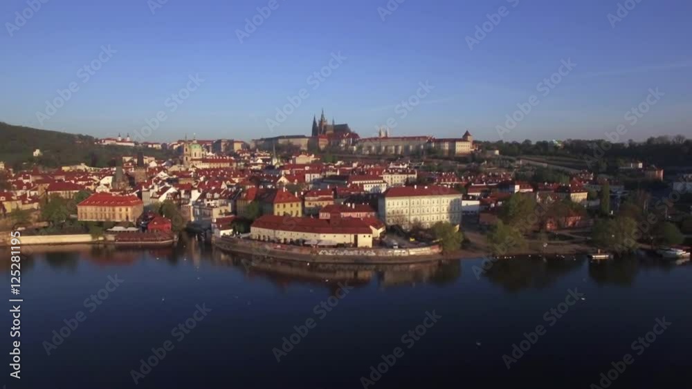 Aerial riverside view of Prague. Red rooftop architecture with Prague Castle dating from 9th century. Czech Republic, Europe Aerial riverside view of Prague. Red rooftop architecture with Prague Castle dating from 9th century. Czech Republic, Europe