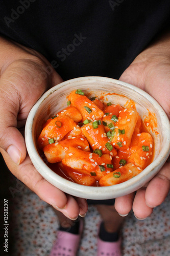 Rice cake korean food on hands photo