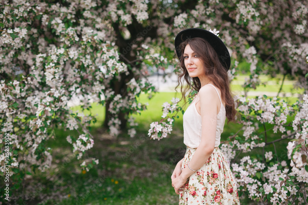portrait of young lovely woman in spring flowers, 20s portrait of young lovely woman in spring flowers, 20s
