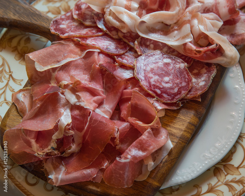 Typical various italian salami, servided on plate at restaurant.