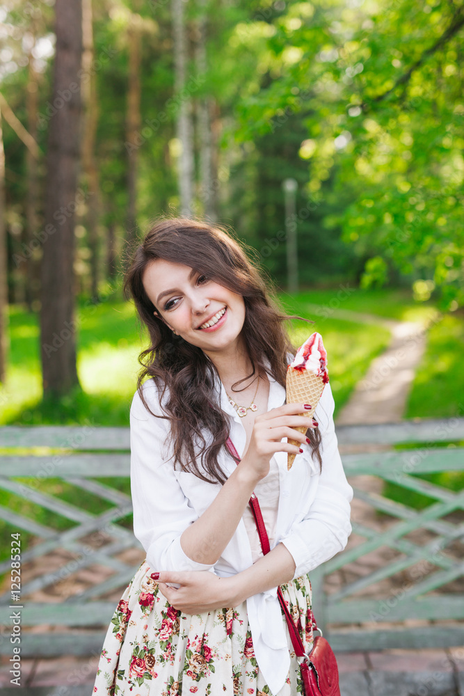 Outdoor closeup portrait of girl eating ice cream in summer Outdoor closeup portrait of girl eating ice cream in summer